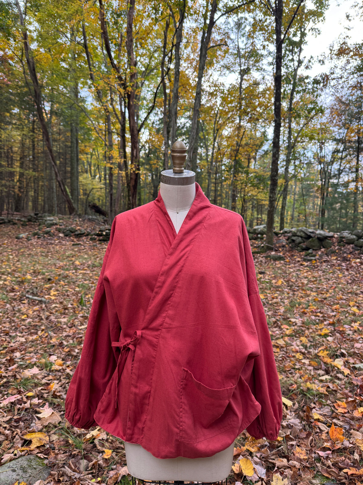 Red reversible wrap jacket tied at the side, with balloon sleeves and a patch pocket