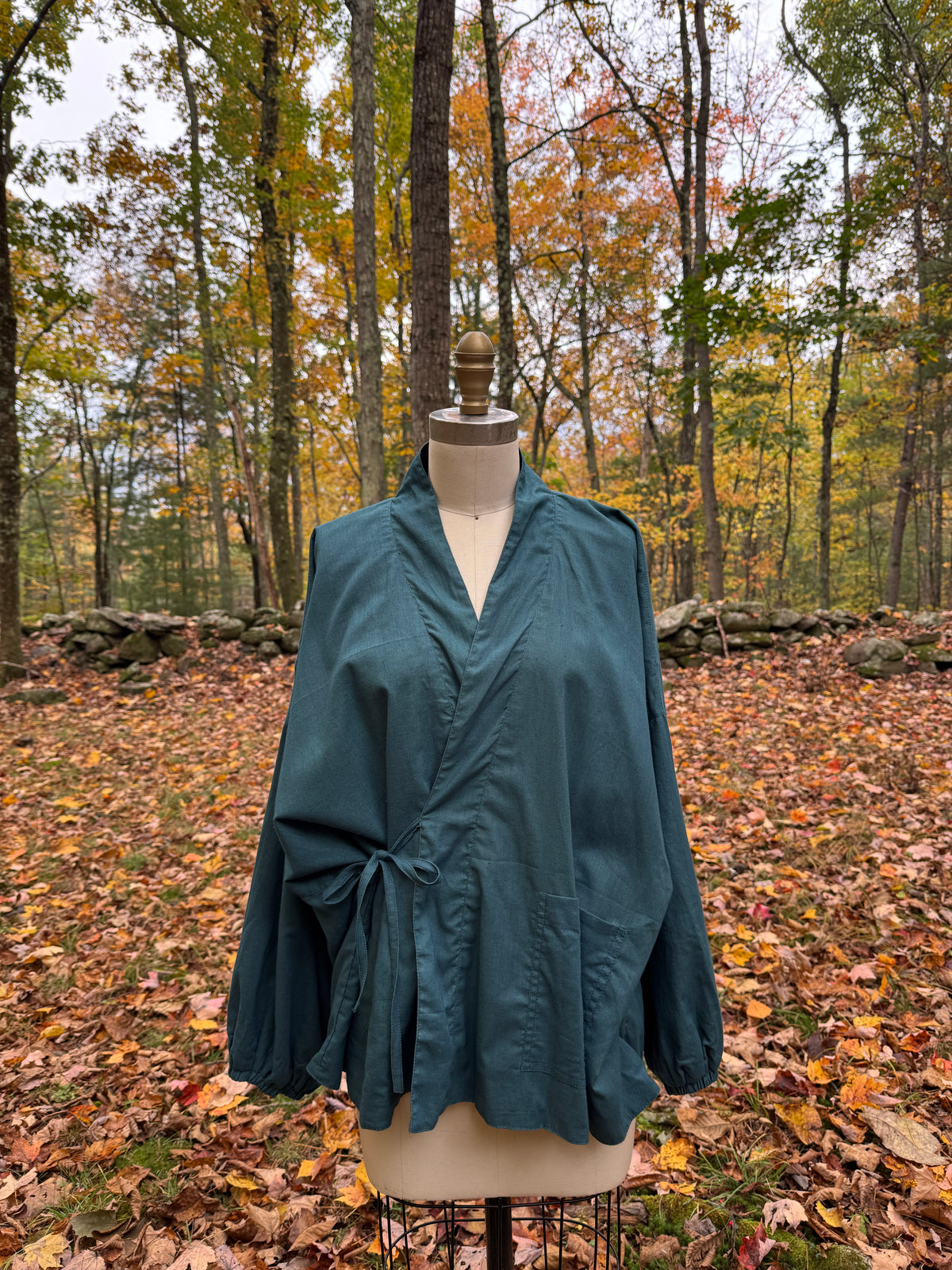 Teal reversible wrap jacket tied at the side, with balloon sleeves and a patch pocket